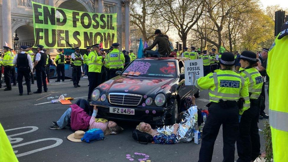 Some protesters glued and locked themselves to a car in the road at Marble Arch