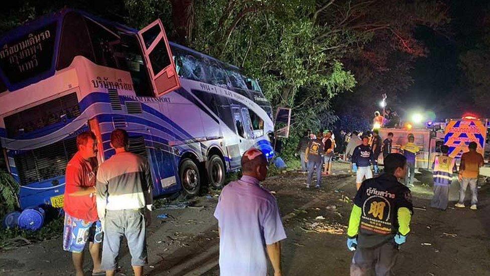 Photo from bus collision showing the vehicle leaning on its side