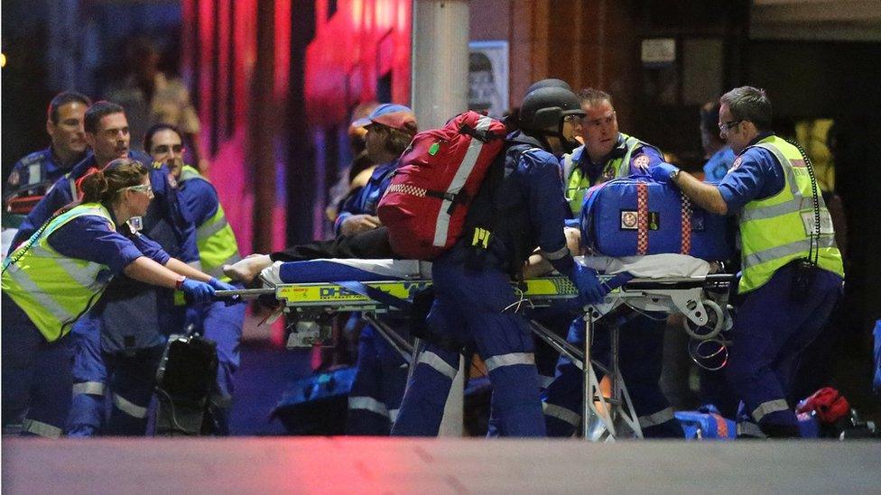 Paramedics attend to a person injured in the Sydney siege