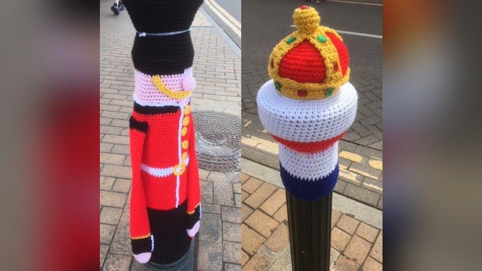 Bollards in Paddock Wood decorated to look like knitted guardsmen and a crown