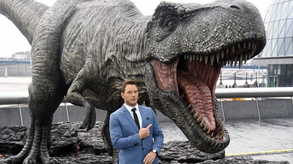 Actor Chris Pratt and a model T-Rex