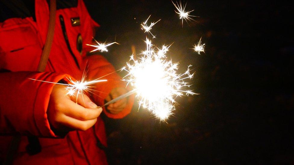 Boy holding sparkler