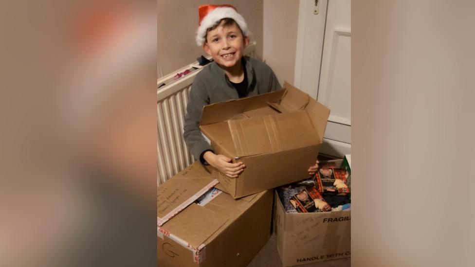 Mason with boxes for homeless collection