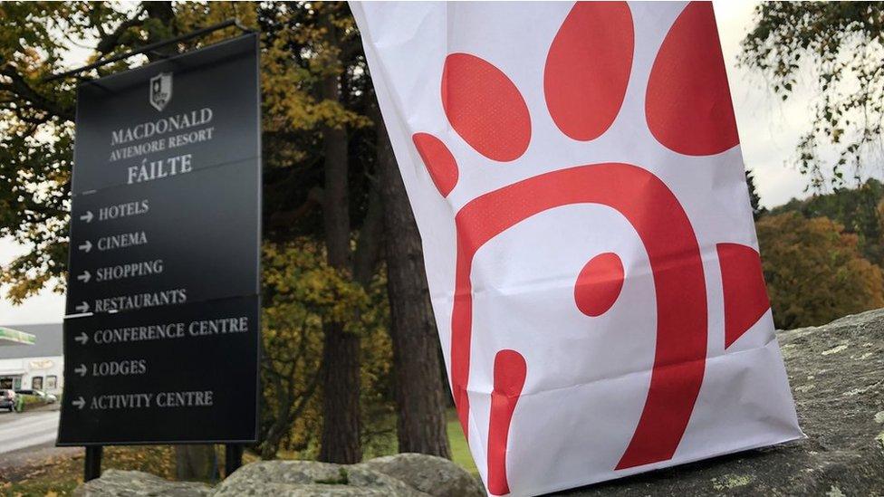 Chick-fil-A bag and MacDonald Aviemore resort sign