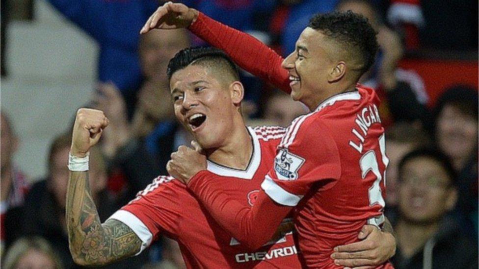 Manchester United's Jesse Lingard (R) celebrates scoring his team's first goal with team mate Marcos Rojo