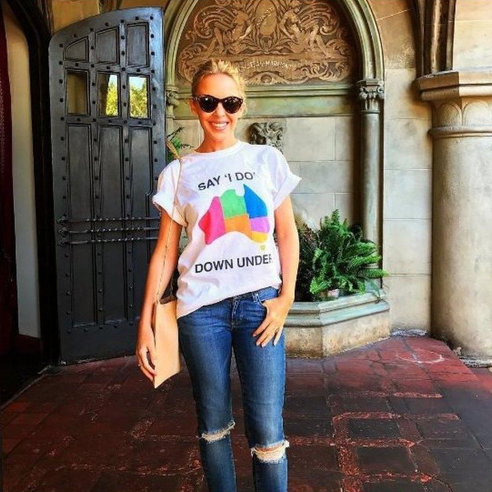 Kylie Minogue shows her support for marriage equality by wearing a "Say I Do Down Under" T-shirt