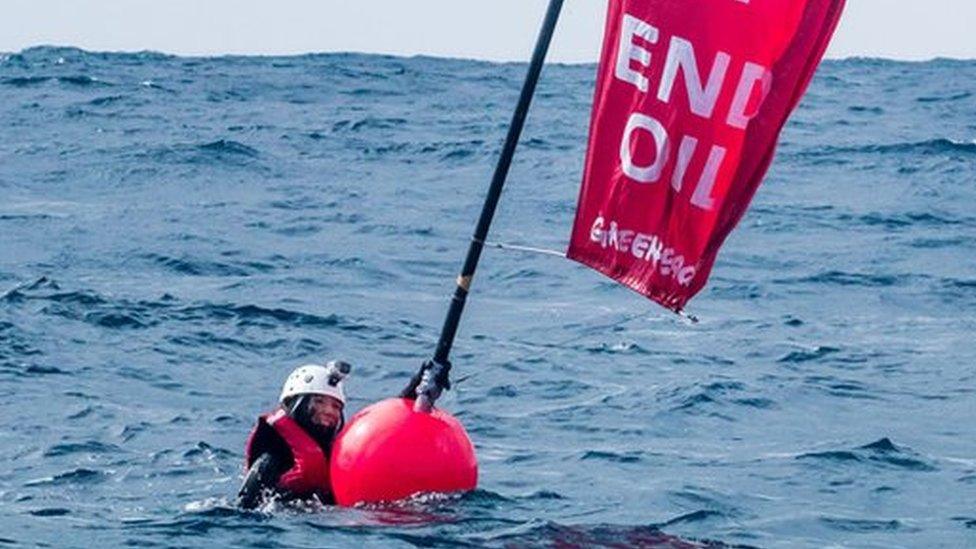 Sara in the water with a buoy