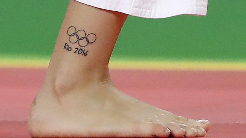 A tattoo of the Olympic rings is seen on the leg of Turkey's Busra Katipoglu during the women's -63kg judo contest match against Macedonia's Katerina Nikoloska during the Rio 2016 Olympic Games in Rio de Janeiro on August 9, 2016