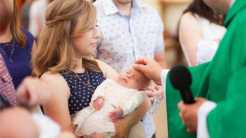 A baby being christened