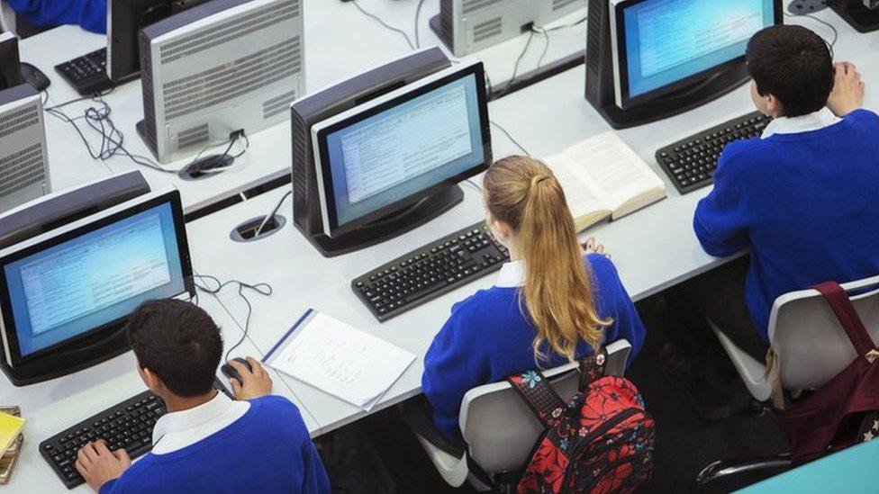 Children working on computers in a classroom