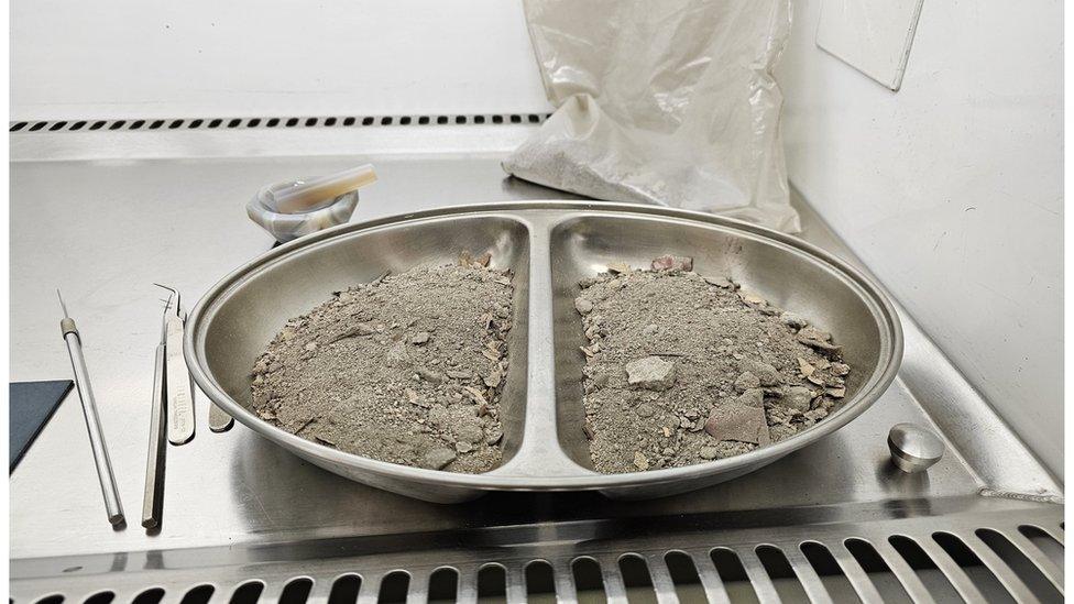 Dust in a metal tray in a testing facility