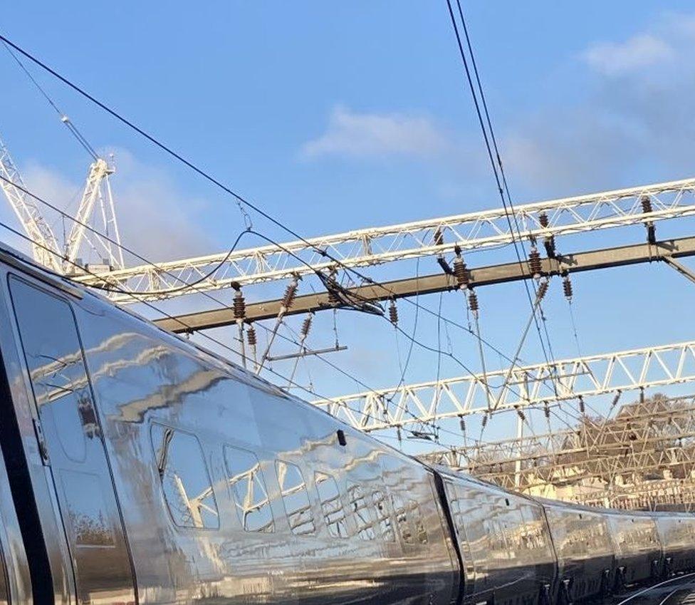 Overhead wires to power the trains snapped above a passing train