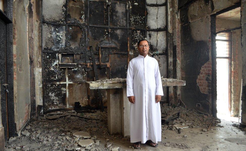 Father Anthony inside the fire-damaged church