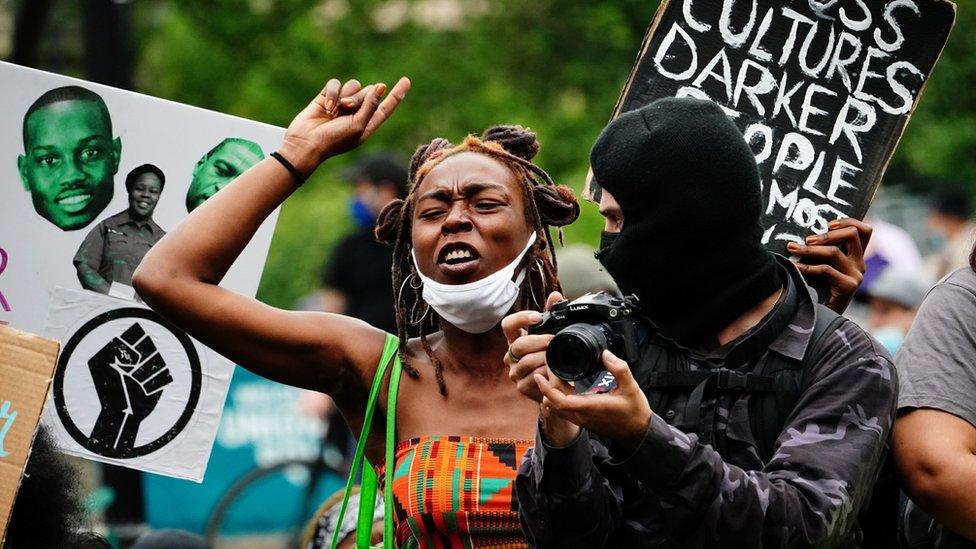 woman-protesting-in-new-york-next-to-photographer