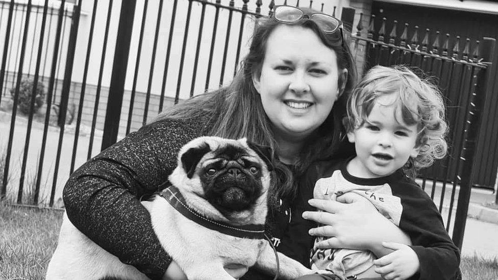 Samantha Brown hugging her son Harry and a pug