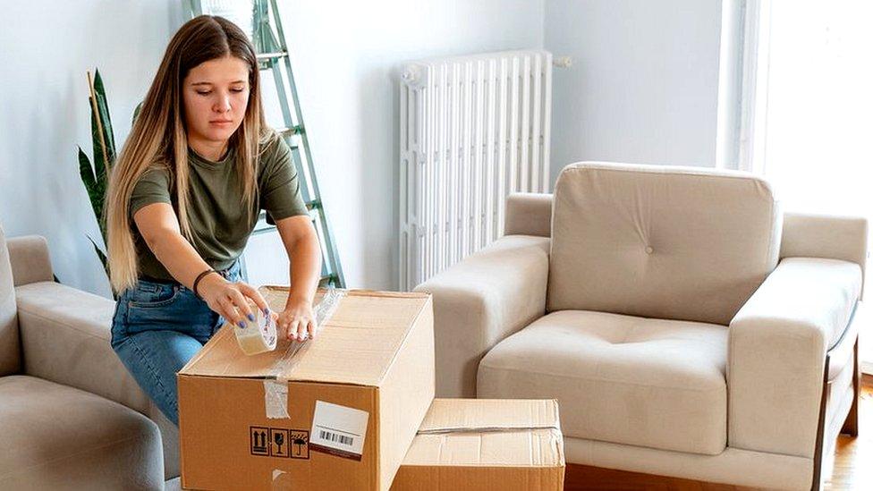 Woman unpacking boxes in a flat