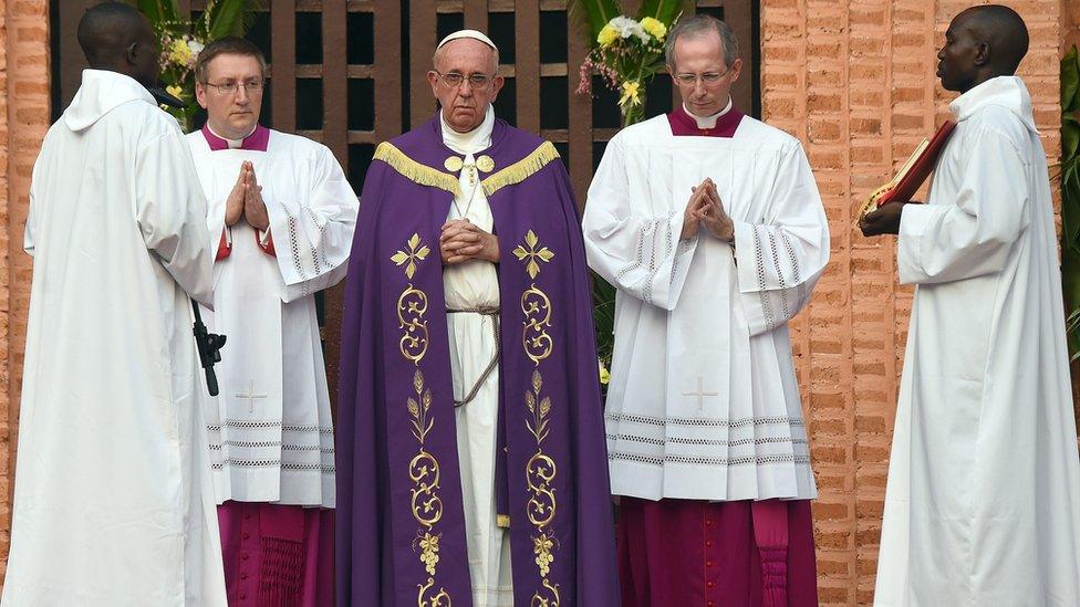 Pope Francis (C) prepares to lead a mass with priests, religious, catechists and youths, after opening the "Holy Door" at the Bangui Cathedral in Bangui