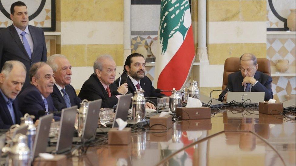 Lebanese President Michel Aoun (R) and Prime Minister Saad Hariri (2nd R) attend a cabinet meeting at the presidential palace of Baabda,