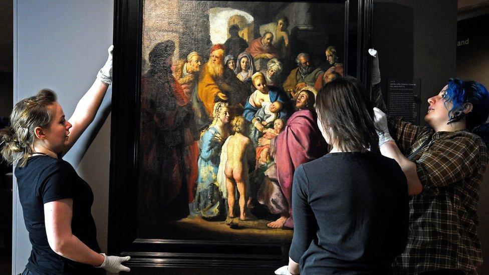 Art handlers moving the painting at the Ashmolean Museum in Oxford