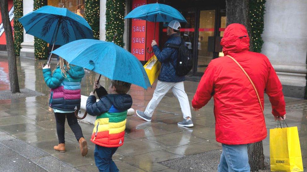 Shoppers in the rain