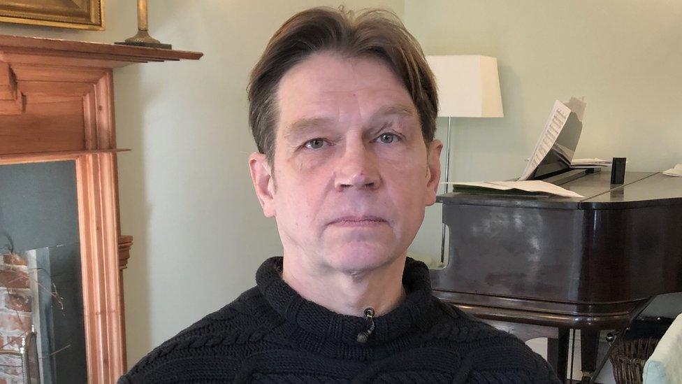 Boris Konoshenko photographed at home in Norfolk with a piano in the background