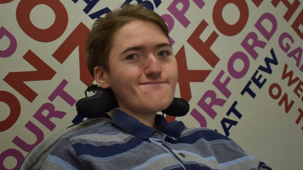 Ben in front of a BBC Local Radio sign