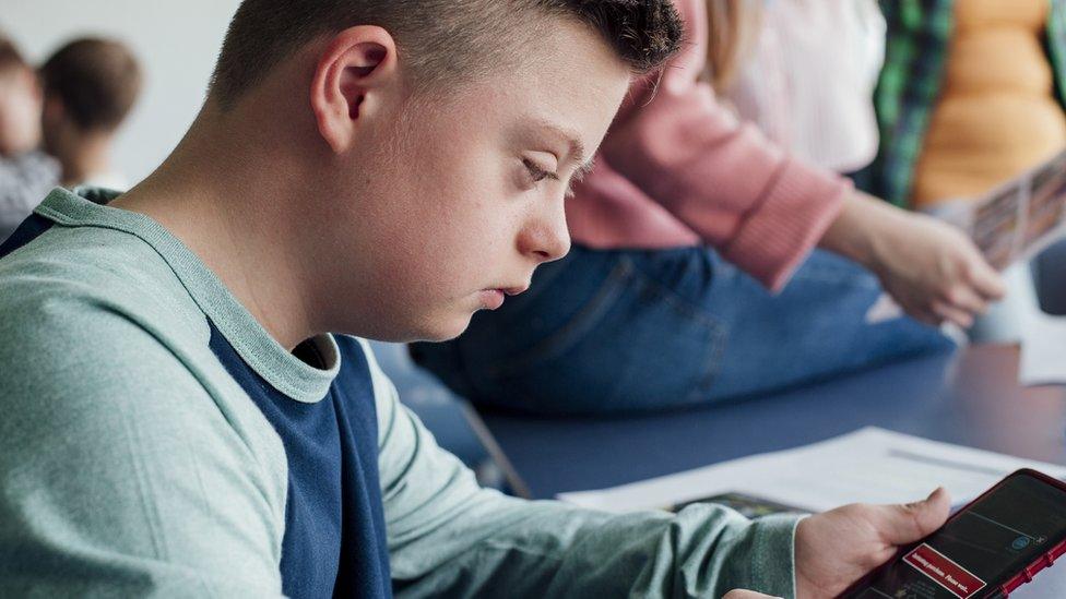 Teenage using technology within school lesson.