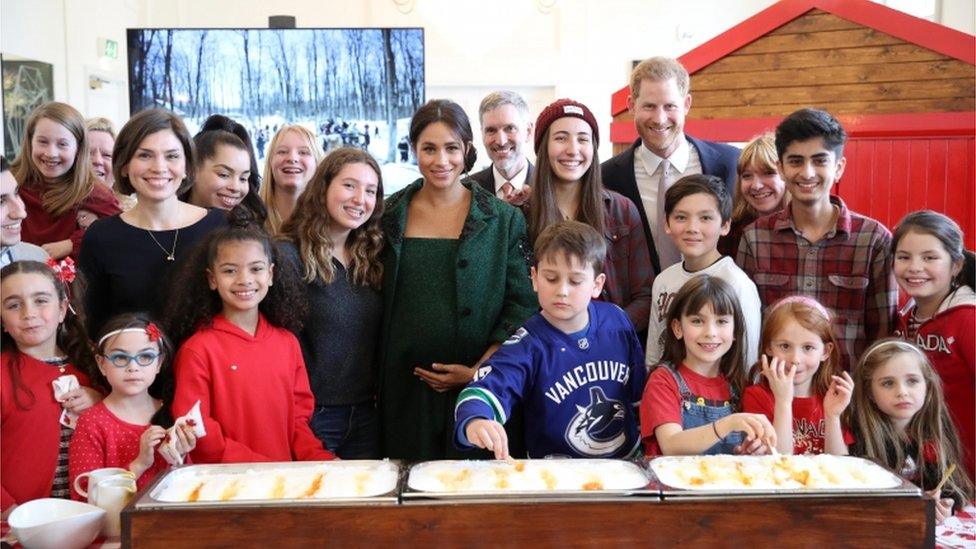 Prince Harry and Meghan posed with young people after making maple taffy, which is maple syrup cooled on snow to make sweets.