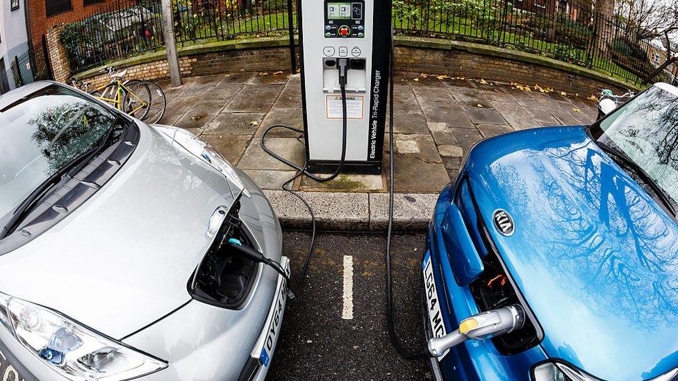 Two cars at electric charge point