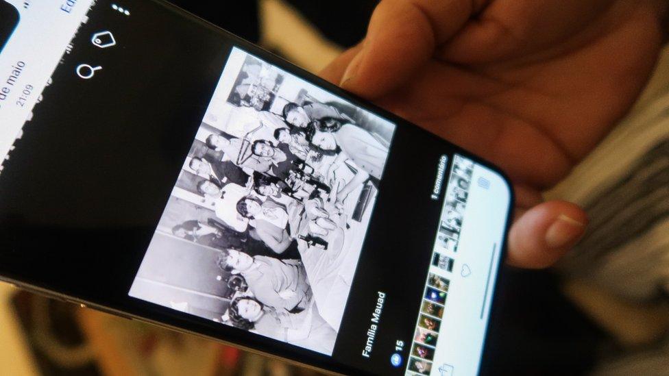 Heloisa Daher shows an old family photo on her phone