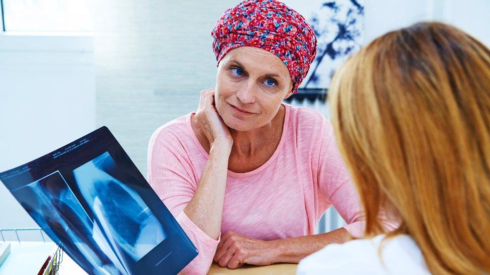 A doctor and woman with cancer