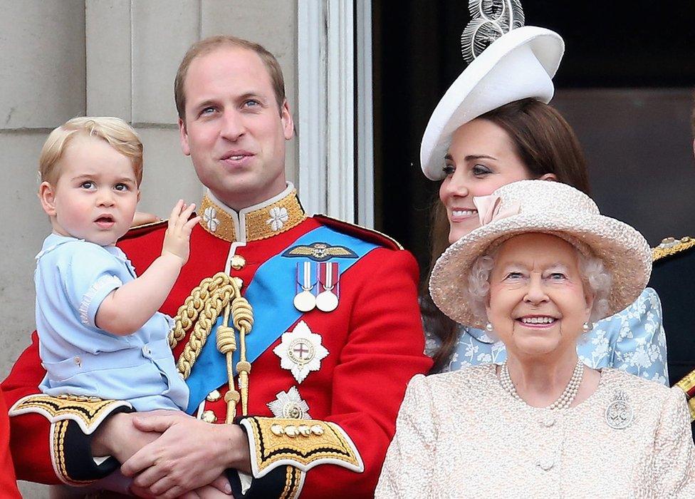 Prince William carrying Prince George, alongside the Duchess of Cambridge and the Queen