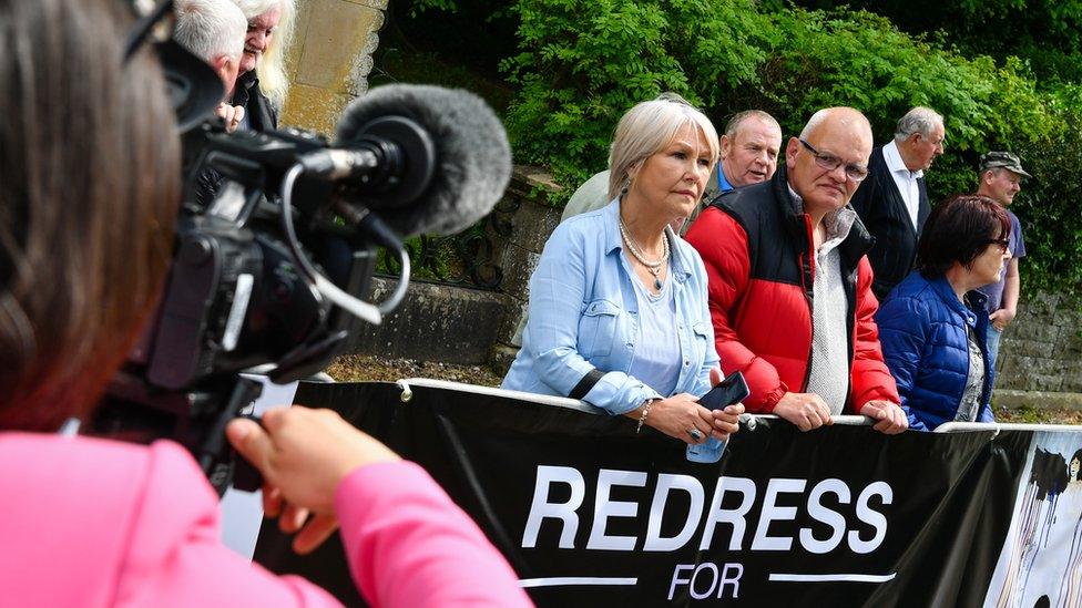 Campaigners protect outside the Northern Ireland secretary's garden party in Enniskillen