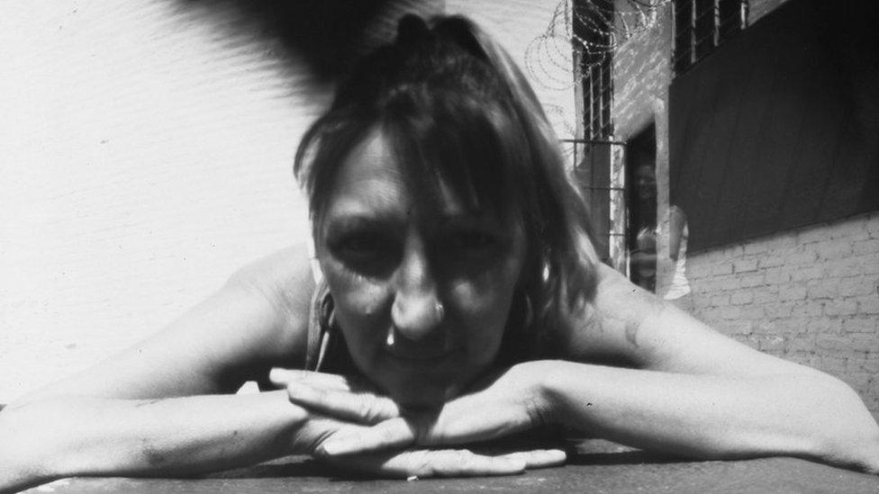 A pinhole photograph shows a woman