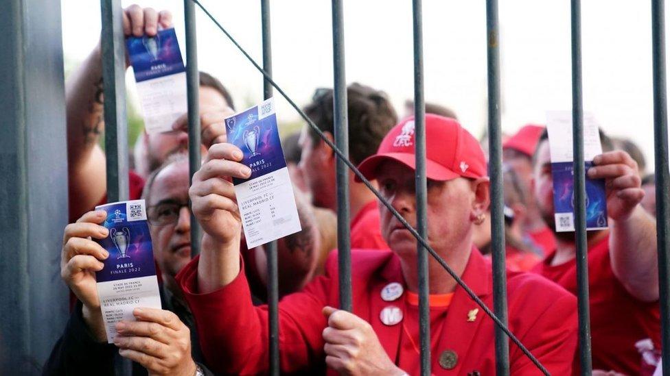 Liverpool fans hold up tickets outside the Stade de France for the Champions League Final in Paris in 2022