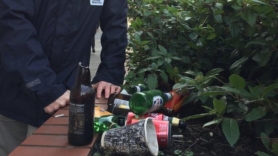 Christopher Allen with rubbish gathered in bushes outside the BBC