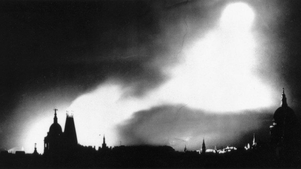 Bombs lighting the night sky over London during the Blitz.