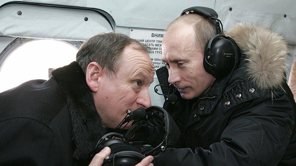 Mr Putin and Mr Patrushev on a helicopter to visit a military outpost