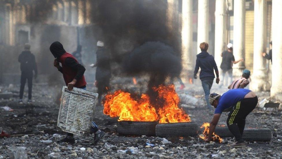 Protesters near the Ahrar Bridge in Baghdad, where at least four people died