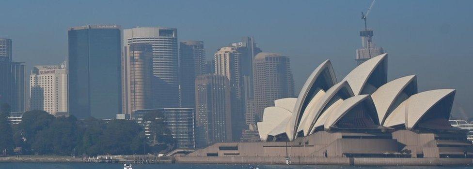 Sydney Opera House and the city skyline seen through a layer of smoke