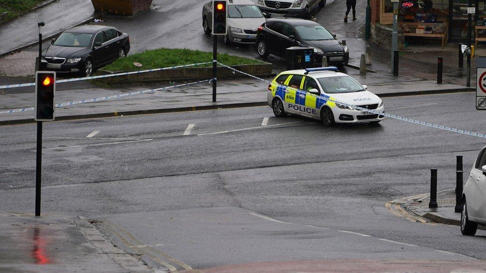 A police car and cordon at scene