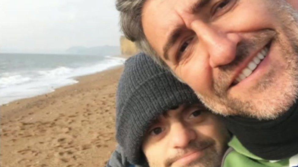 A selfie of Reuben and Manni Coe on a beach