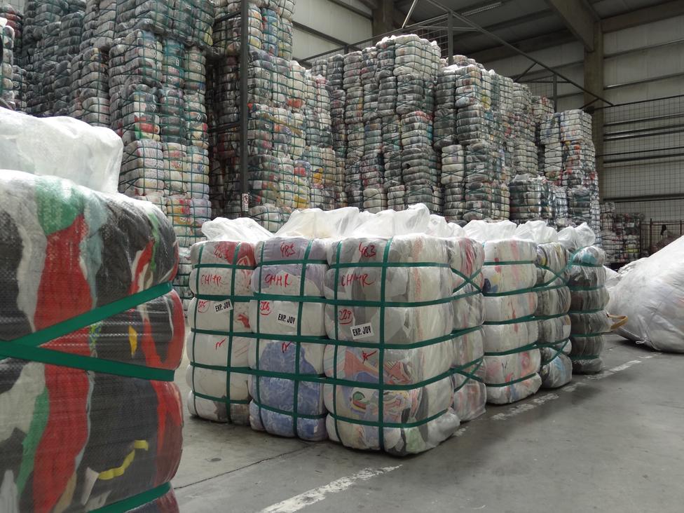 Tied-up bales of clothes in warehouse