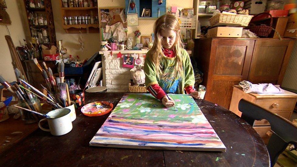 A young girl painting