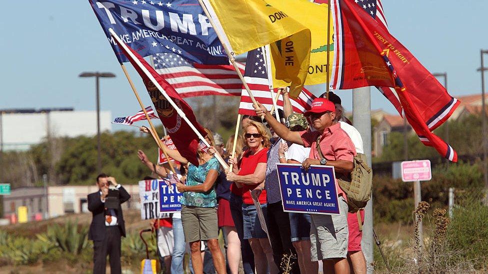 Trump supporters wave flags outside a rally in California.