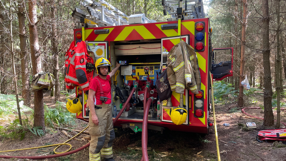 Firefighter and fire engine in forest at Ickburgh