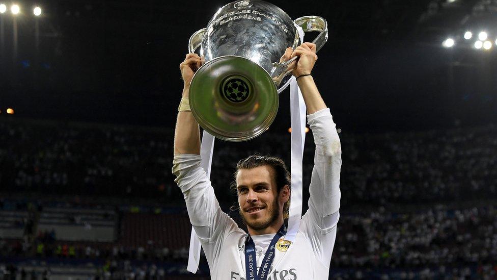 Gareth Bale holds the Champions League trophy aloft