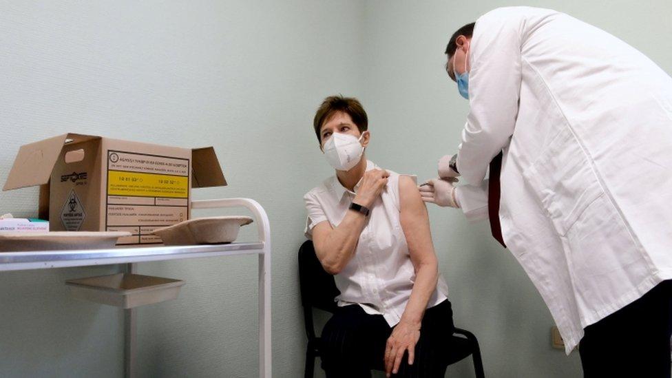 Healthcare worker Adrienne Kertesz receives the first injection nationwide of the Pfizer-BioNTech jab