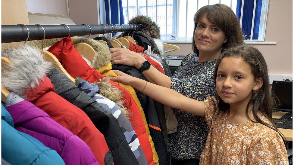 Lydia and her mum with coats