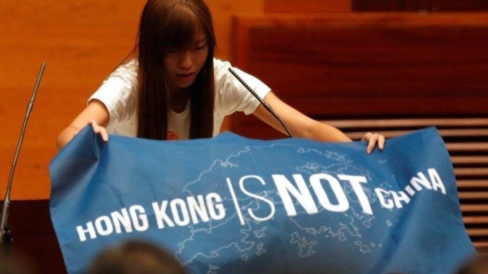 Newly elected lawmaker Yau Wai-ching displays a banner before taking oath at the Legislative Council in Hong Kong, China October 12, 2016.